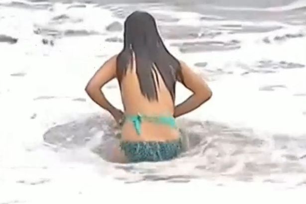 Jr high girl losses bikini on beach