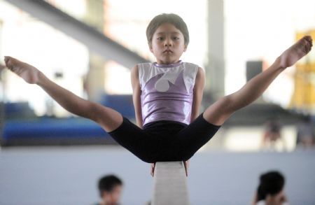 Naked girl on balance beam